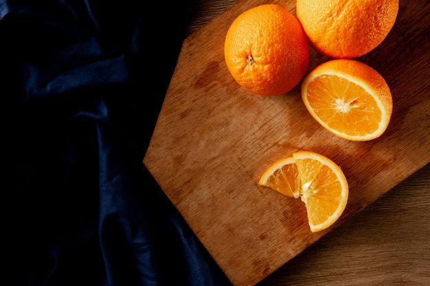 Grated oranges with slices on wooden background top view and closeup