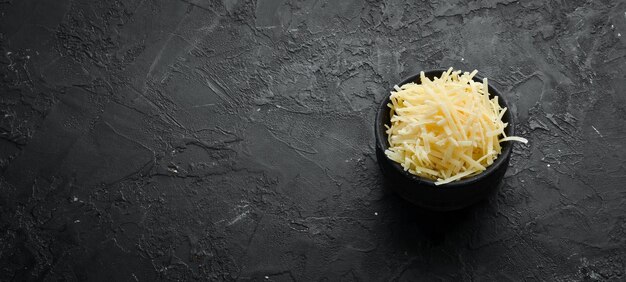 Grated Parmesan cheese in a bowl Top view Free space for your text