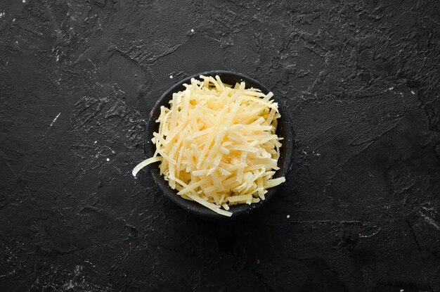 Grated Parmesan cheese in a bowl Top view Free space for your text