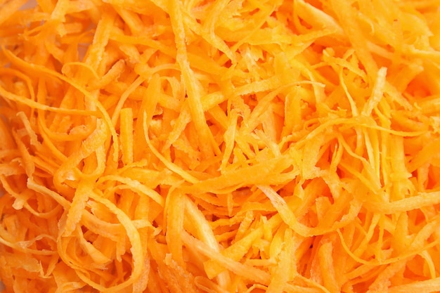 Grated ripe carrot as background
