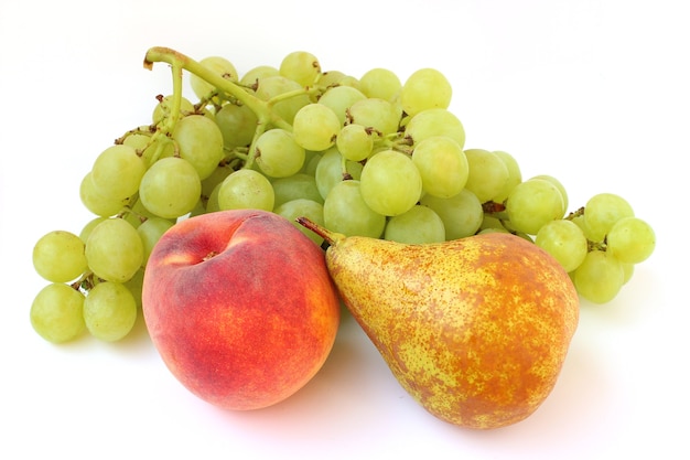 The grave of green grapes, pear and peach are isolated