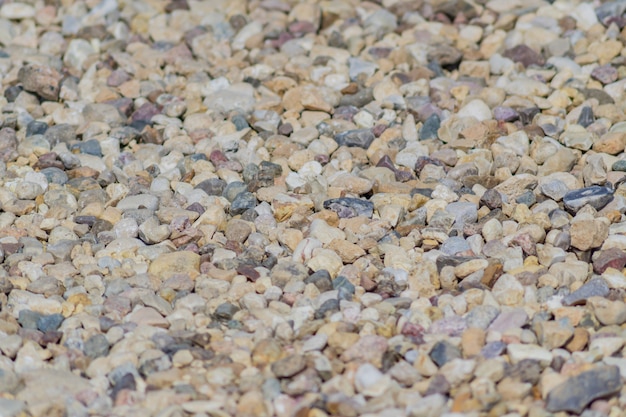 Gravel background texture. Close up of little stones on the ground. Selective focus.