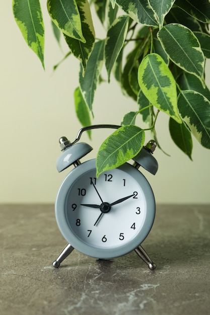 Gray alarm clock on gray table