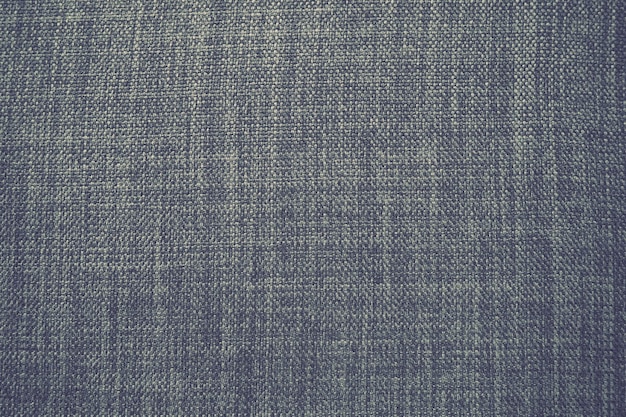 Trama di tessuto di sfondo grigio un pezzo di stoffa di lana è ben disposto sulla trama superficiale e t
