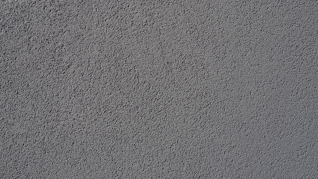 Gray background neatly plastered gray or black wall rough\
texture velvety effect professional finishing of walls interiors\
facades of buildings and premises construction and design