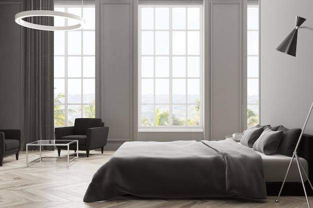 Серый интерьер спальни с деревянным полом, главной кроватью с висящей над ней лампой и большими окнами. 3d рендеринг макет
