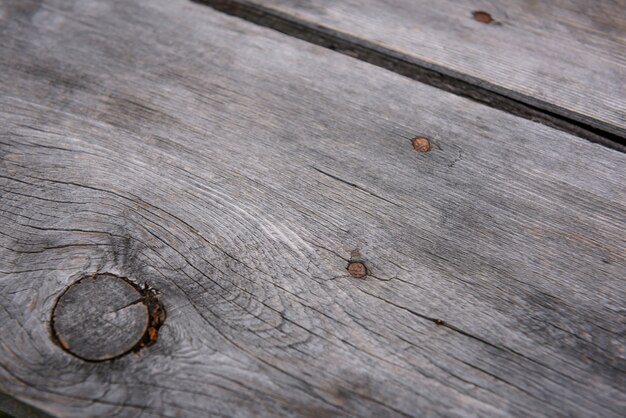 Photo gray board with rusty nails, close-up