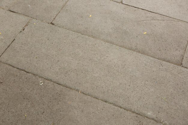 Серый кирпичный каменный тротуар текстуры фона
