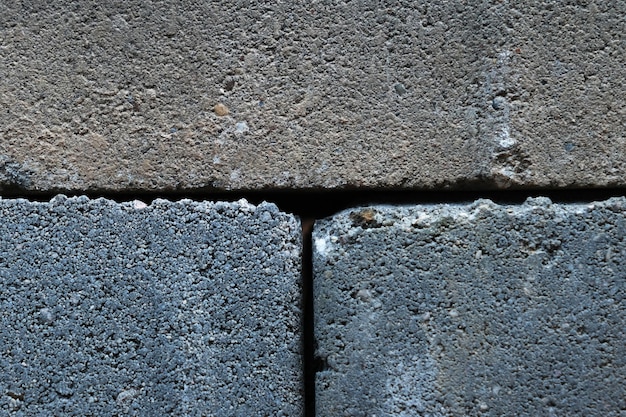 Gray building cinder blocks made of cement stacked closeup background Lot of large concrete bricks stacking texture