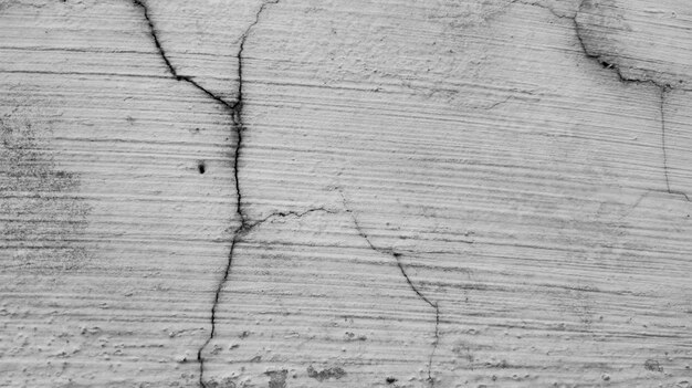 Photo gray cement wall background texture with cracked pattern