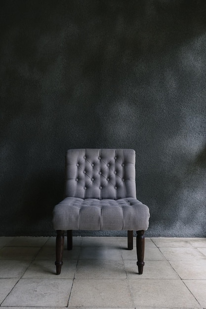 Gray chair in concrete room for copy space Concept of minimalism