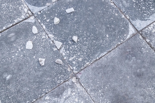 Gray chipped paving slabs in the city