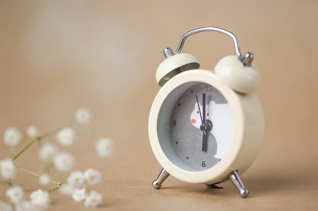 Gray clock with a bear pattern on a brown blurred background