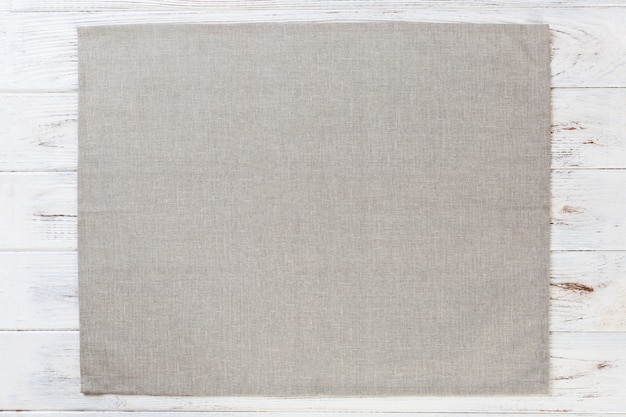 Gray cloth napkin on white rustic wooden surface