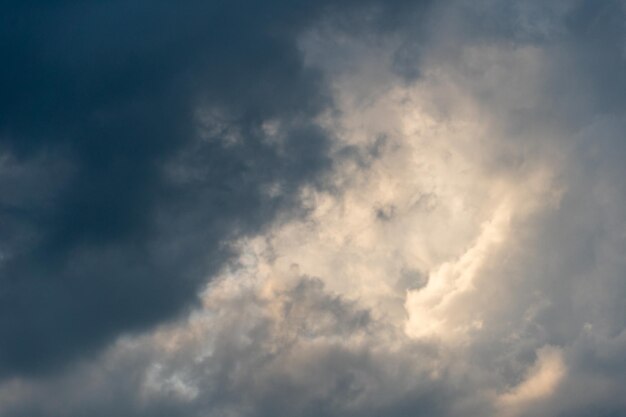 Gray clouds The sky before the rain and thunder Through the gray rain clouds you can see a clear blue sky