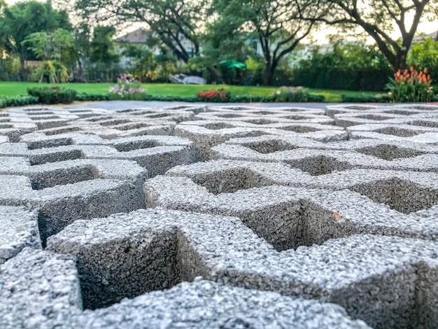 Photo gray color stone brick block floor tile with green grass and sand as background or texture