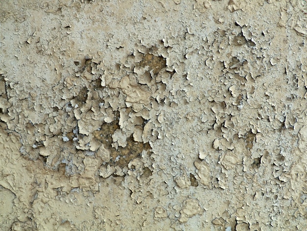 Gray cracked paint on an old wall