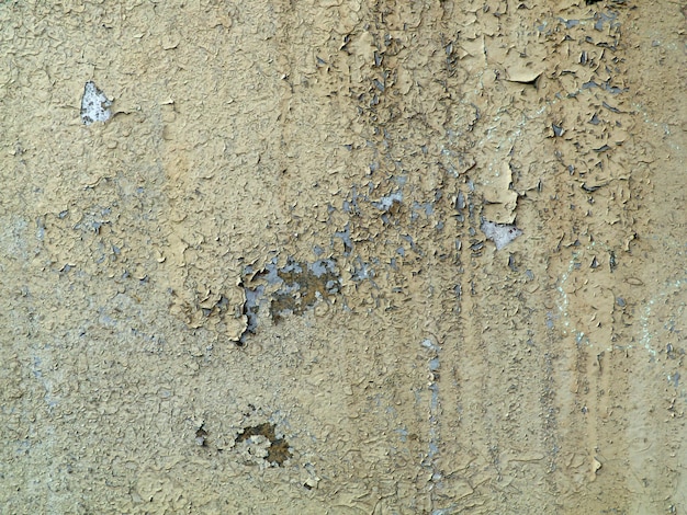 Gray cracked paint on an old wall