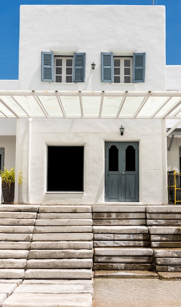 Gray door  on white wall and cement Staircase