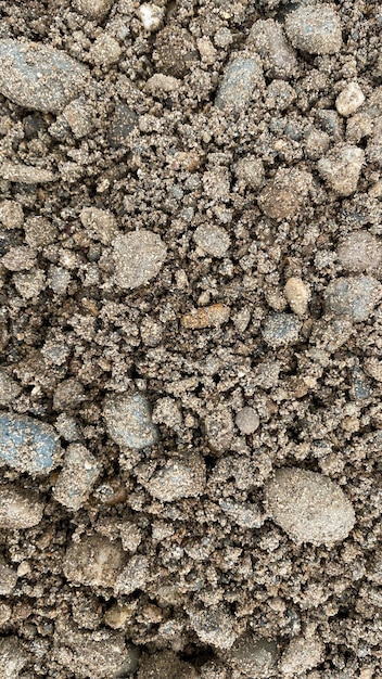 Gray fine stone texture of the soil small black background made of road stone