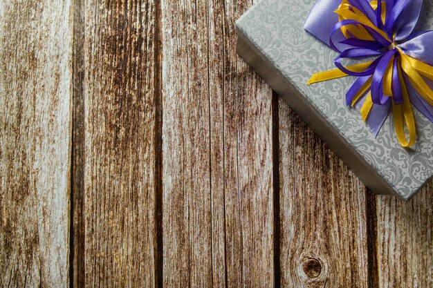 Gray gift box with purple and yellow bow