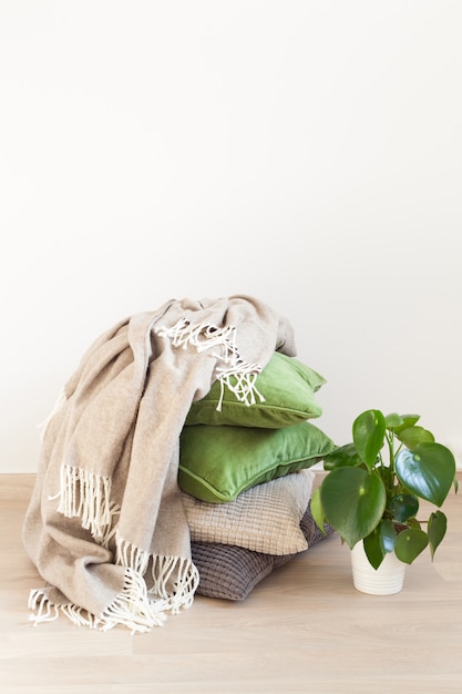 Gray and green pillows on the floor