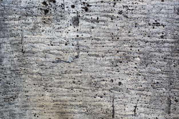 Gray Grunge texture of old damaged roofing paper with spots.