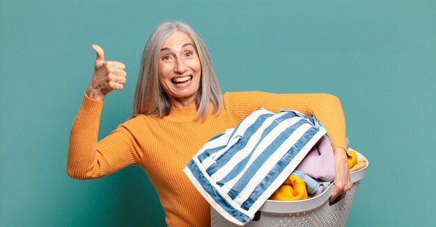 Gray hair pretty housekeeper woman washing clothes