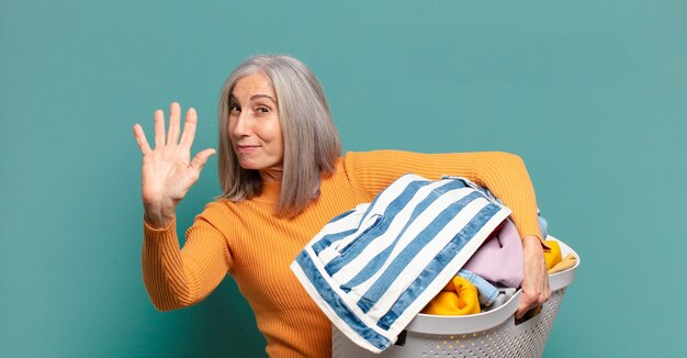 Gray hair pretty housekeeper woman washing clothes