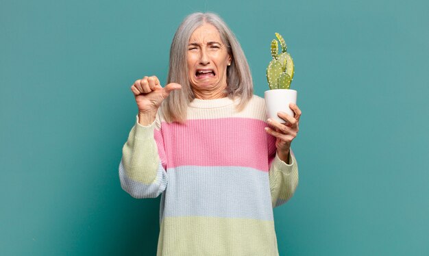 Gray hair pretty woman with a cactus