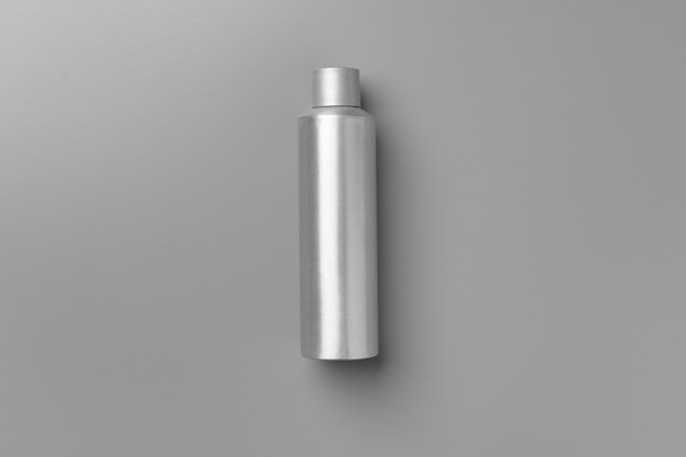 Gray haircare product on gray background top view