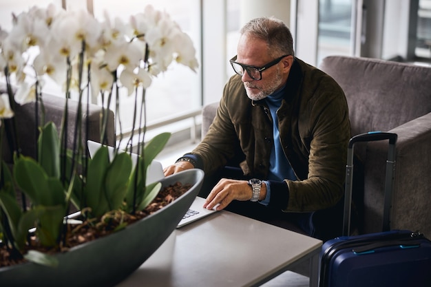 Gray-haired man staring at his laptop screen