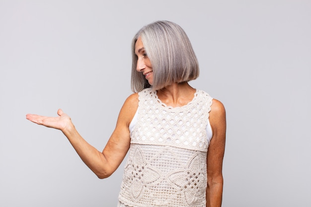 Gray haired woman feeling happy and smiling casually