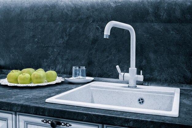 Gray kitchen interior with mixer and apples on a platter