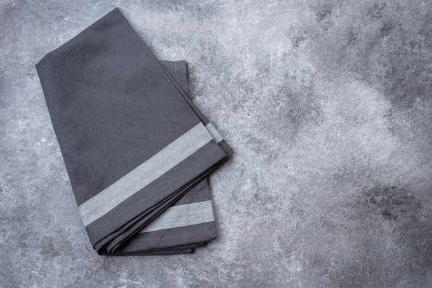 Gray Kitchen Towel on Gray Stone Table Background. 