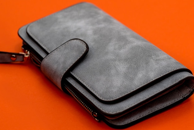 Gray leather wallet on orange