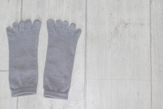 Gray nonslip yoga socks with toes on the floor