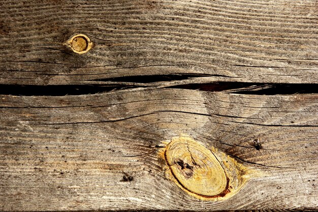 gray old wooden board texture with yellow twigs, wooden background