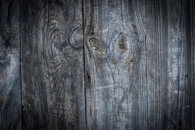 Gray old wooden surface with knots and cracks