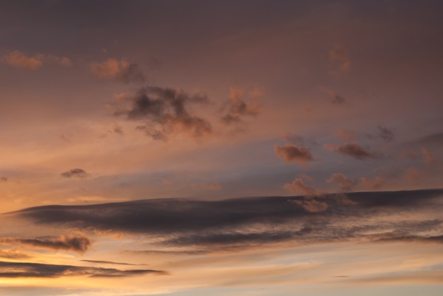 Gray and orange clouds at sunset. Horizontal photo