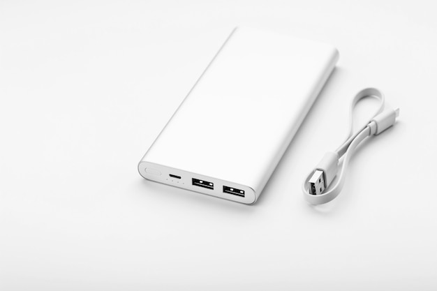 Gray power bank on white surface free space