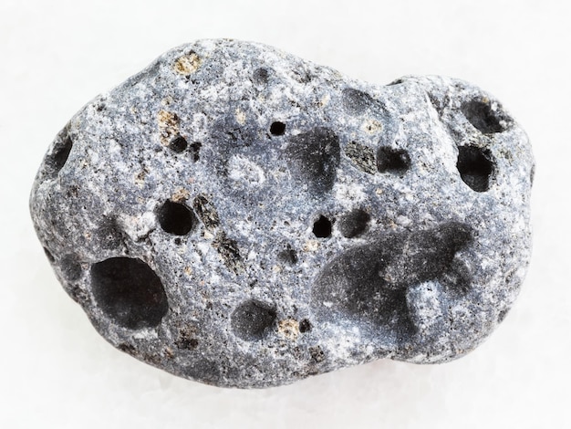 Gray pumice stone on white marble background