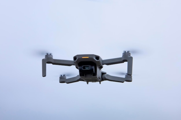 Gray quadcopter drone in flight