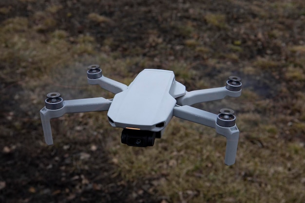 Gray quadcopter drone in flight