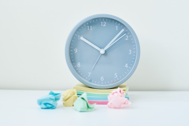 Gray round alarm clock and colorful sticky notes