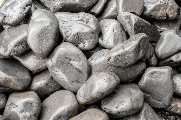 Gray rounded stones background. Natural wet stones texture