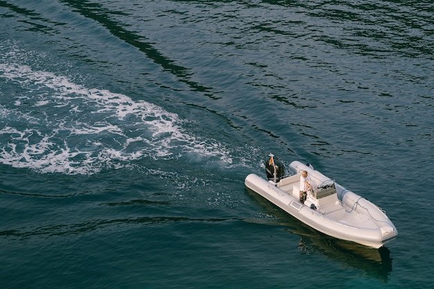 A gray rubber boat floats on the sea