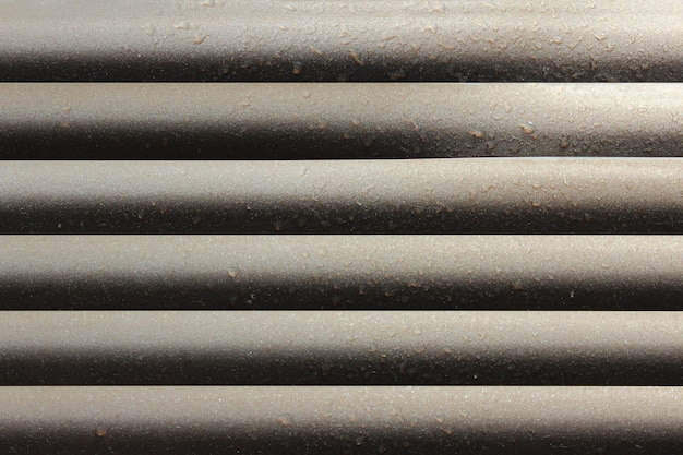 Gray strips of jalousie horizontal on the window