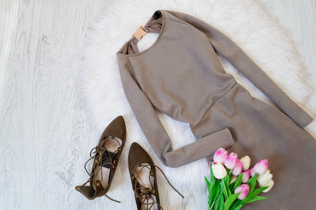 Gray suede dress, brown shoes and a bouquet of tulips.