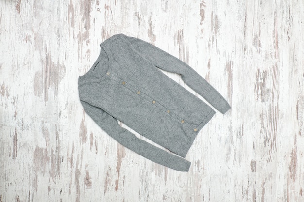 Gray sweater on a wooden background